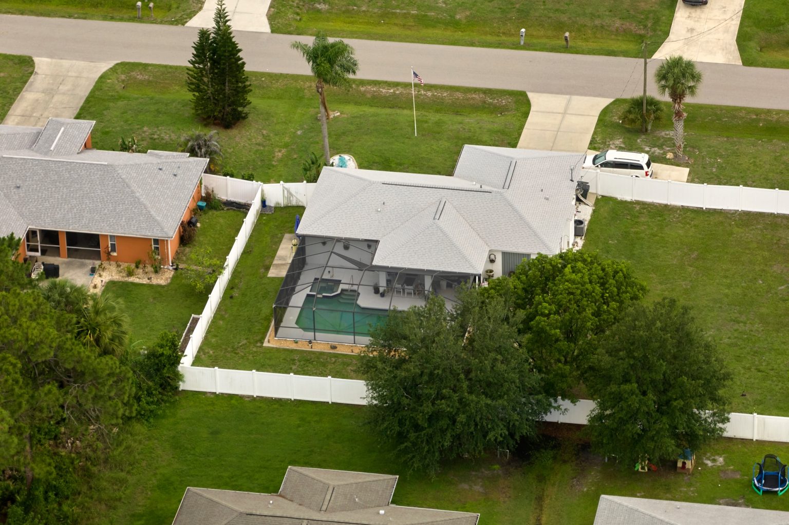 Aerial landscape view of suburban private houses between green palm trees in Florida